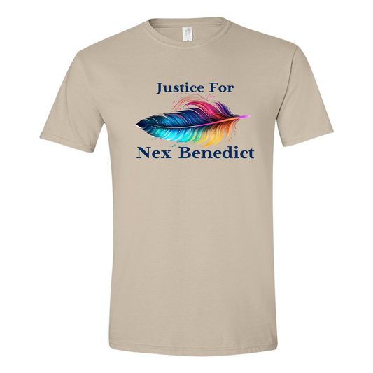 This is a picture of the front of the shirt. The front of the shirt features the words Justice for then a rainbow feather with splashes of color coming off of it and below the feather Nex Benedict. The font is a deep navy blue from the feather. The shirt is Sand colored.